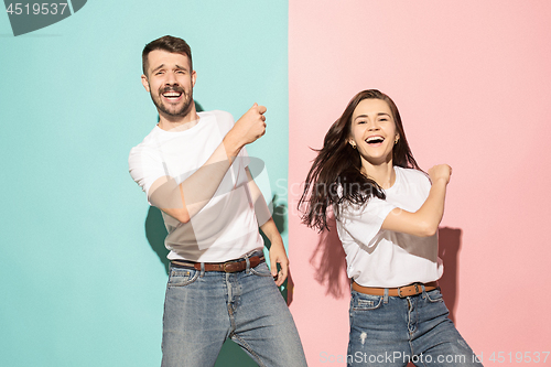 Image of A couple of young man and woman dancing hip-hop at studio.