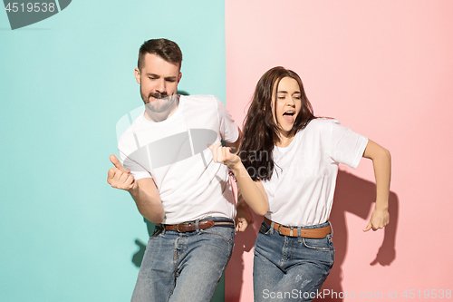 Image of A couple of young man and woman dancing hip-hop at studio.