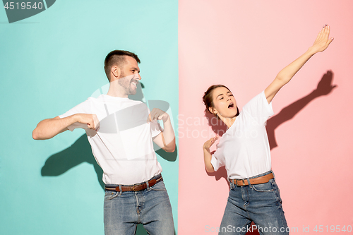 Image of A couple of young man and woman dancing hip-hop at studio.