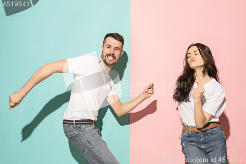 Image of A couple of young man and woman dancing hip-hop at studio.