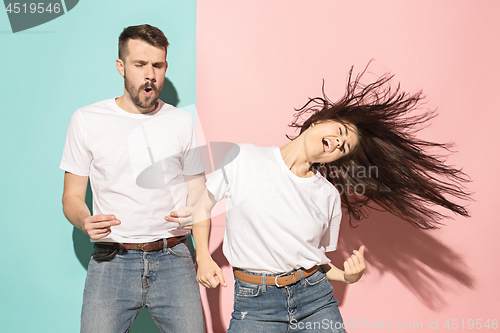 Image of A couple of young man and woman dancing hip-hop at studio.