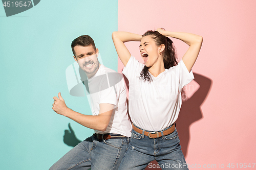 Image of A couple of young man and woman dancing hip-hop at studio.