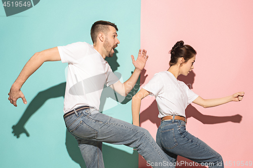 Image of A couple of young man and woman dancing hip-hop at studio.