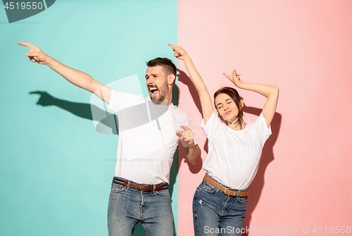 Image of A couple of young man and woman dancing hip-hop at studio.