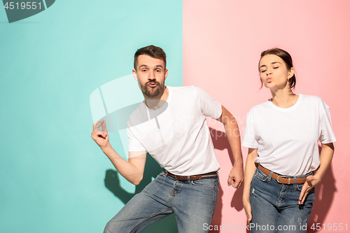 Image of A couple of young man and woman dancing hip-hop at studio.