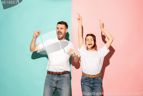 Image of A couple of young man and woman dancing hip-hop at studio.