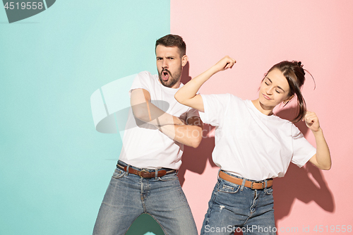 Image of A couple of young man and woman dancing hip-hop at studio.