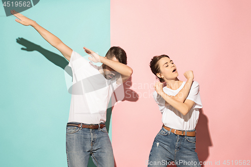 Image of A couple of young man and woman dancing hip-hop at studio.