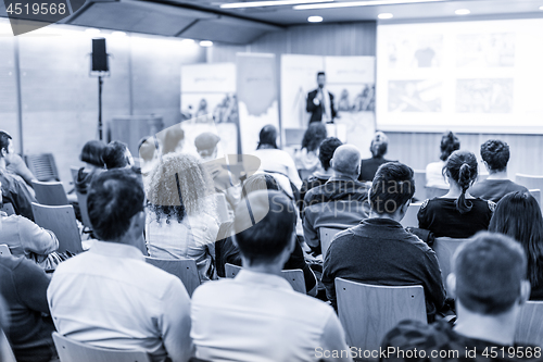 Image of Business speaker giving a talk at business conference event.