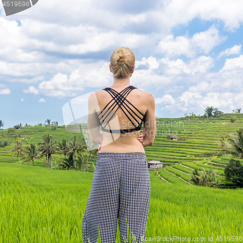 Image of Relaxed casual sporty woman enjoying pure nature at beautiful green rice fields on Bali.