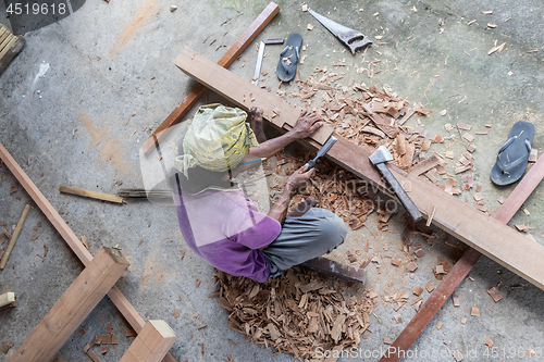 Image of Carpenter working in traditional manual carpentry shop in a third world country.