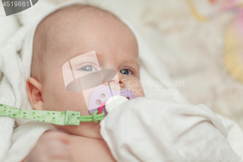 Image of A portrait of a baby boy with a baby dummy