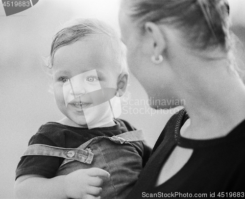 Image of Loving mother with baby girl in arms. Black and white