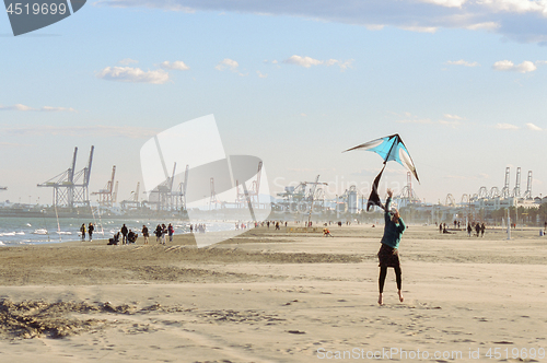 Image of Flying a kite on winter beach
