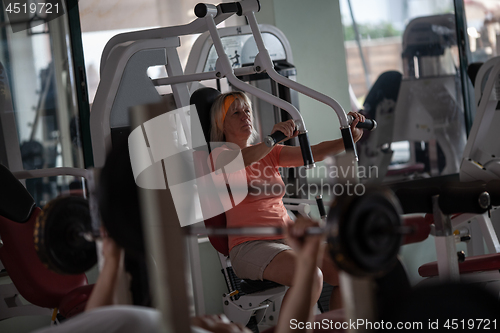 Image of A fair haired senior woman working out in a gym