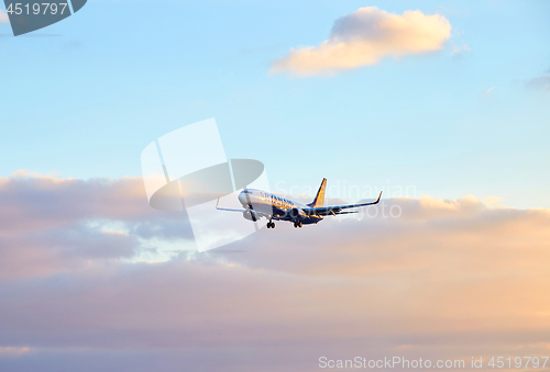 Image of Ryanair airplane flying at sunset