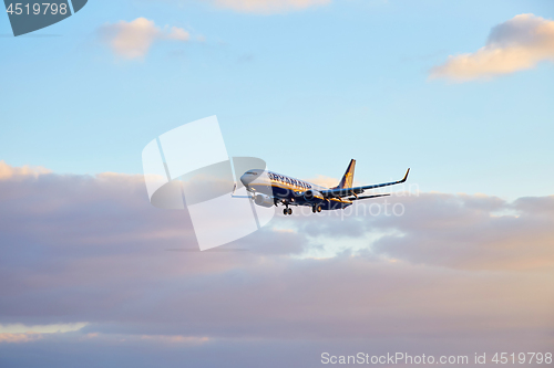 Image of Ryanair airplane flying at sunset