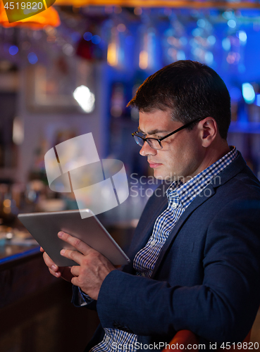 Image of He cannot get away from his job even in the bar