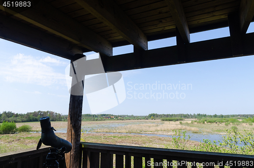 Image of Spotting scope on a tripod in a bird watching tower