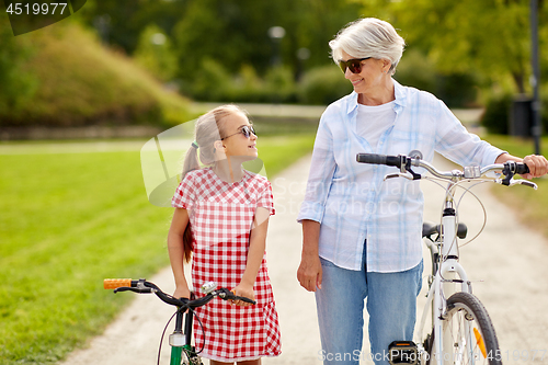 Image of grandmother and granddaughter with bicycles