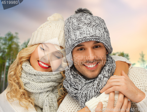 Image of couple hugging over winter forest background