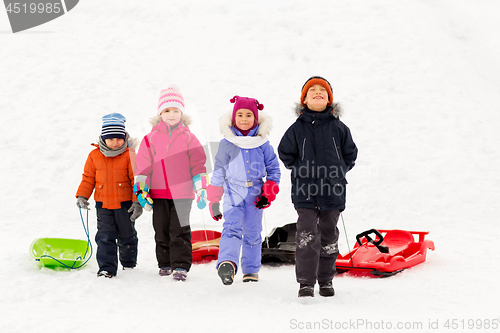 Image of happy little kids with sleds in winter