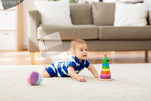 Image of sweet little asian baby boy with toys at home