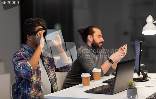 Image of creative man in virtual reality headset at office