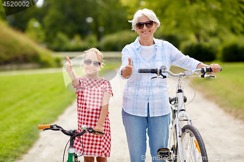 Image of grandmother and granddaughter with bicycles