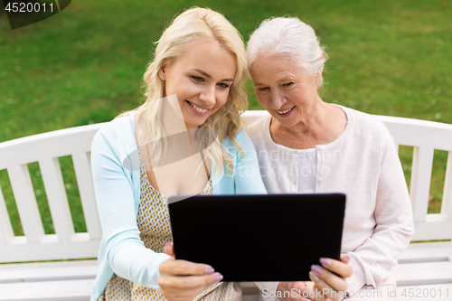 Image of daughter with tablet pc and senior mother at park