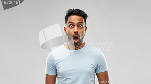 Image of shocked or scared man over grey background