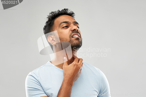 Image of indian man suffering from neck pain or sore throat