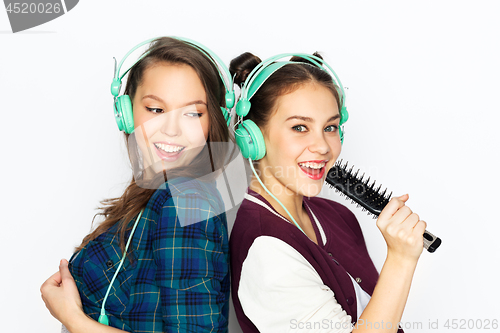 Image of teenage girls in earphones listening to music