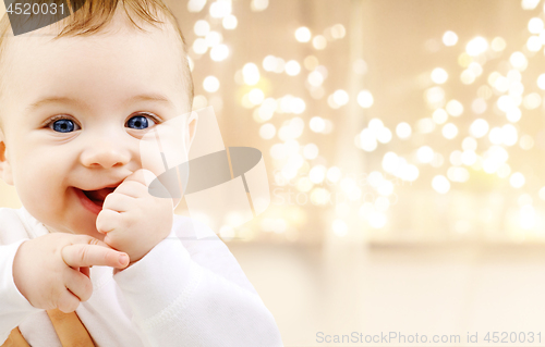 Image of close up of sweet baby over christmas lights