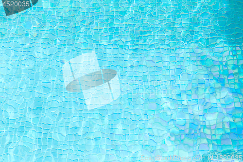 Image of turquoise water in tiled swimming pool