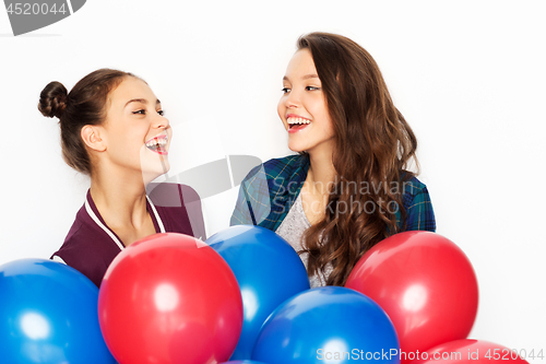 Image of happy teenage girls with helium balloons