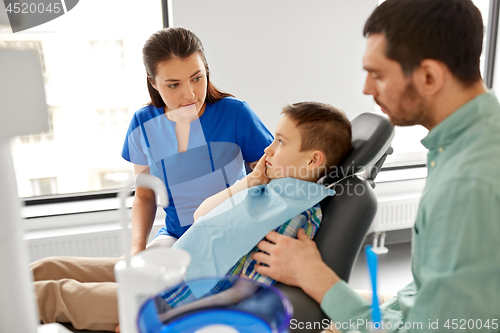 Image of father and son visiting dentist at dental clinic