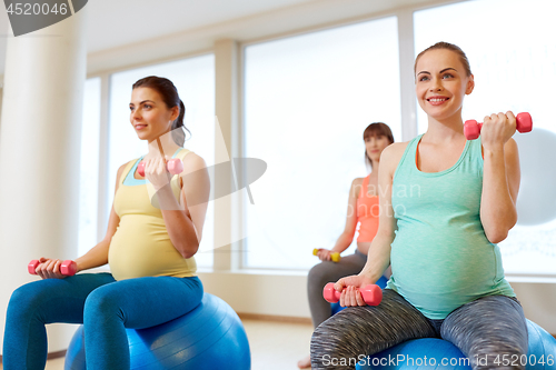 Image of pregnant women training with exercise balls in gym