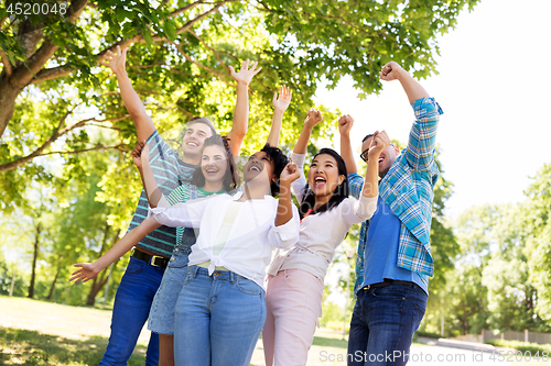 Image of group of happy smiling friends having fun outdoors