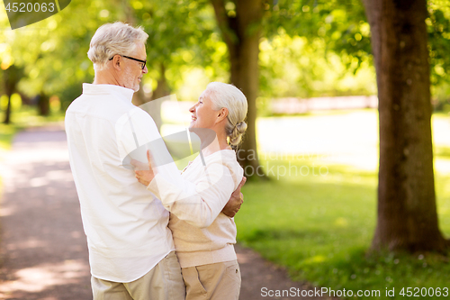 Image of happy senior couple dancing at summer park