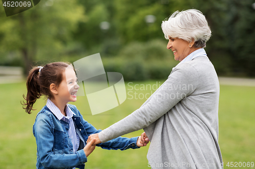 Image of grandmother and granddaughter playing at park