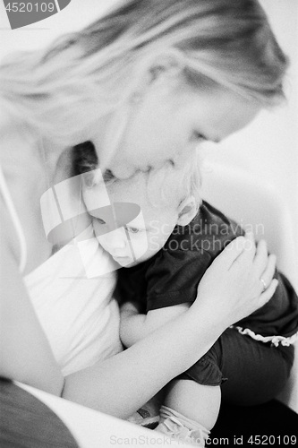 Image of In the hugs of dear mother. Black and white family portrait