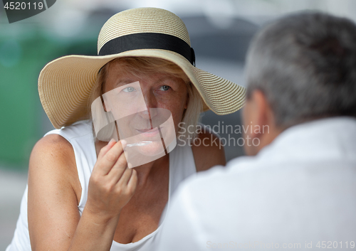 Image of Mature woman in outside cafe