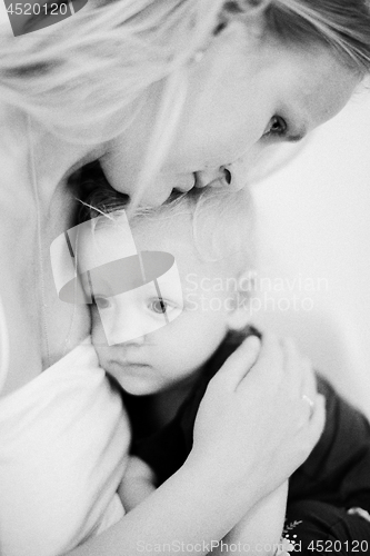 Image of Mum embracing little daughter. Black and white shot