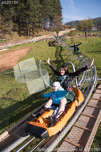 Image of mother and son enjoys driving on alpine coaster