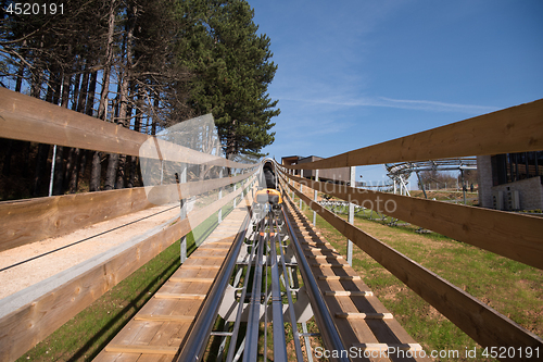 Image of mother and son enjoys driving on alpine coaster