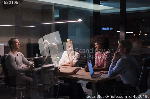 Image of Multiethnic startup business team in night office