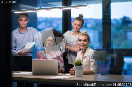 Image of Multiethnic startup business team in night office