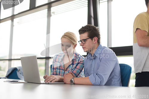 Image of Two Business People Working With laptop in office