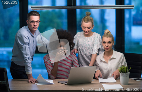 Image of Multiethnic startup business team in night office